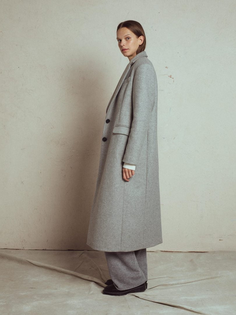 wool coat birla 2 from unlabel fall collection. classic men style silhouette with shoulder pads, satin lining, long slit at the back, with side pockets with flaps, front hidden buttons, italian stiff fabric 100% wool .